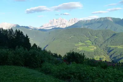a view of a mountain range with trees and mountains at Zolerhof in Feldthurns