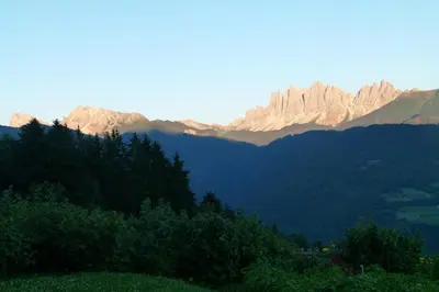 a view of a mountain range with trees and mountains at Zolerhof in Feldthurns