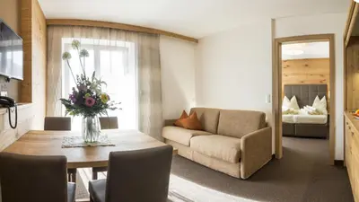 a living room with a couch and a table at mittendorf klimaresidence in Schenna