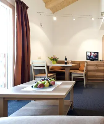 a room with a table with a plate of fruit on it at mittendorf klimaresidence in Schenna