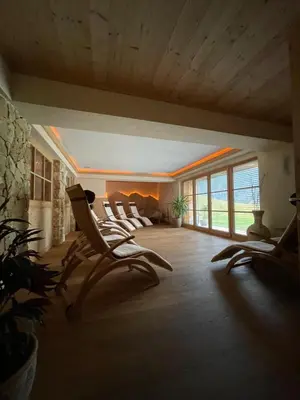a group of chairs in a room with windows at Apartments Ciastel in San Vigilio Di Marebbe