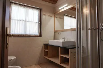 a bathroom with a sink and a mirror at Apartments Ciastel in San Vigilio Di Marebbe