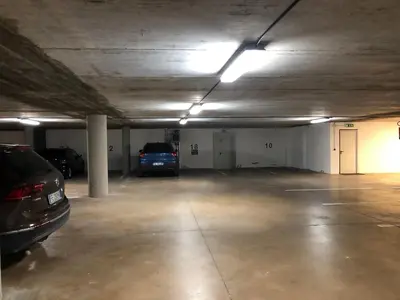 a parking garage with two cars parked in it at Panoramic apartment 71 in San Martino di Castrozza