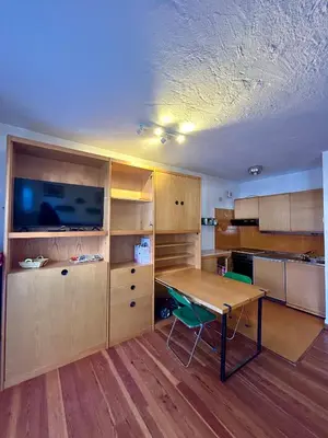 a kitchen with a wooden table and a desk at Panoramic apartment 71 in San Martino di Castrozza