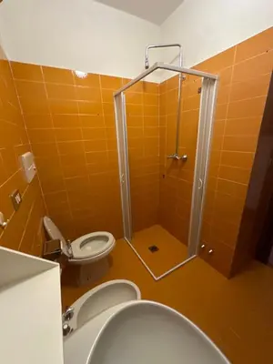 a bathroom with a shower with a toilet and a sink at Panoramic apartment 71 in San Martino di Castrozza
