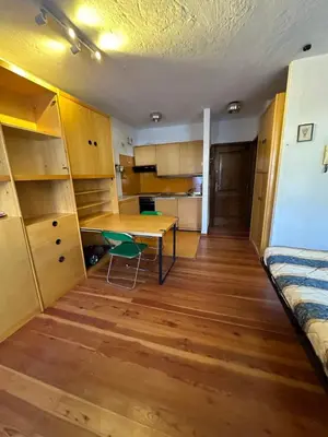 a room with a desk and a table in a room at Panoramic apartment 71 in San Martino di Castrozza
