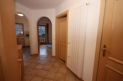 a hallway of a home with a kitchen and a door at Villa Anna in Siusi