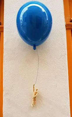 a blue balloon attached to a wall with a dog toy at Apartment Emilie with parking historic city center in Merano