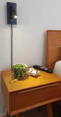 a table with a lamp and a plant on it at Apartment Emilie with parking historic city center in Merano