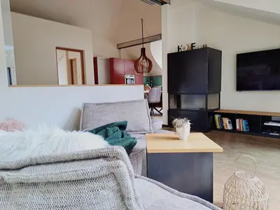 a living room with a couch and a table at Mansarde Zeder in Privatvilla im Zentrum Merans in Merano
