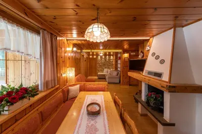 a living room with a couch and a table at Majon d'Aisciuda in Vigo di Fassa