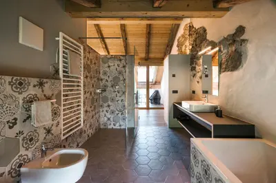 a large bathroom with two sinks and a tub and a tub at St. Vigilius modern historic apartments in Nalles