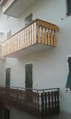 a wooden staircase on the side of a building at Casa Sartori in Tesero