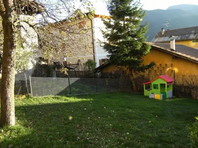 a dog house in the yard of a house at Casa Sartori in Tesero