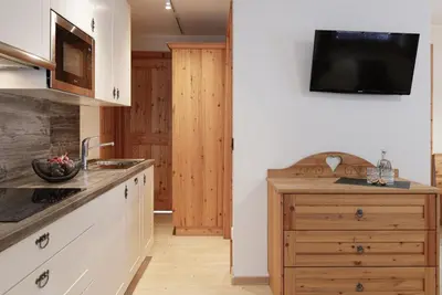 a kitchen with a sink and a counter top at Chalet Tyrolian Apartments - by Familiaris - Pools 500 meters in Valdaora