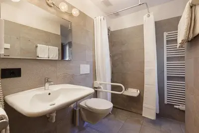 a bathroom with a sink and a toilet and a shower at Chalet Tyrolian Apartments - by Familiaris - Pools 500 meters in Valdaora