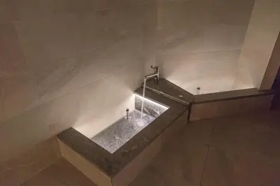 a bathroom with a bath tub with a faucet at Chalet Tyrolian Apartments - by Familiaris - Pools 500 meters in Valdaora
