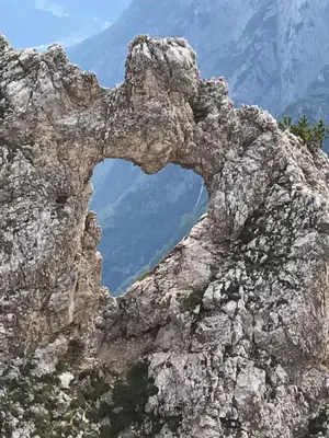 an arch in the rocks of a mountain at Apartment Al Sasso in Taibon