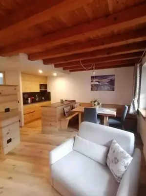 a living room with a white couch and a table at Apartment Al Sasso in Taibon