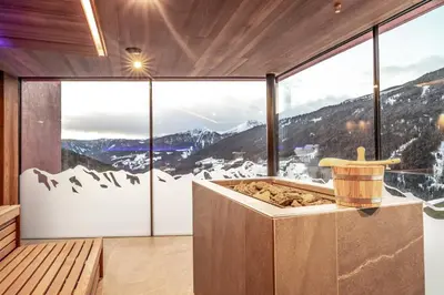 a room with a view of a snowy mountain at Boutique Hotel Kircher in Sarntal