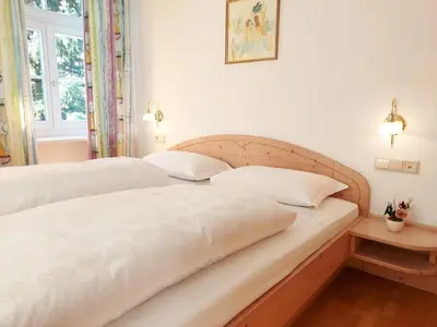 a living room with a couch and a flat screen tv at Residence Zum Theater in Colle Isarco