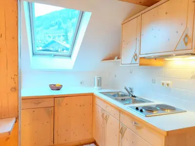 a white bathroom with a sink and a mirror at Residence Zum Theater in Colle Isarco