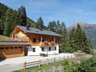 a house in the mountains with a fence at Kröllhof in Vallarga