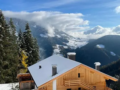 a cabin with a snow covered roof on a mountain at Kröllhof in Vallarga