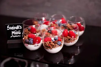 a group of glasses filled with yogurt and berries at Steindl's Boutique Hotel in Vipiteno