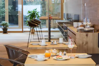a restaurant with a table with food and drinks on it at Steindl's Boutique Hotel in Vipiteno