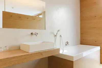 a bathroom with a white sink and a mirror at Steindl's Boutique Hotel in Vipiteno