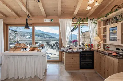 a kitchen with a table and a large window at Tirolerhof - panoramic apartments in Naz-Sciaves