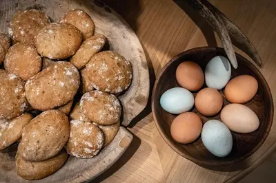 two bowls of eggs and doughnuts on a table at Tirolerhof - panoramic apartments in Naz-Sciaves