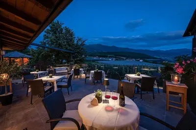 a restaurant with tables and chairs with a view at Tirolerhof - panoramic apartments in Naz-Sciaves