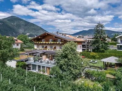 an aerial view of a house with mountains in the background at Tirolerhof - panoramic apartments in Naz-Sciaves