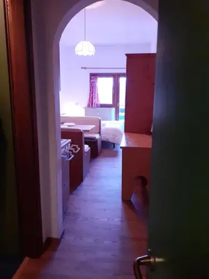 an open door to a room with a living room at Casa Neve e Sole - presso Sussy Residence in Falcade