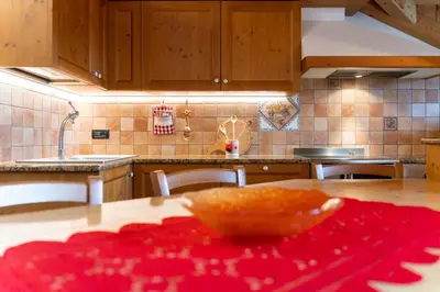 a kitchen with a table with a bowl on it at Mansarda Cermis in Cavalese