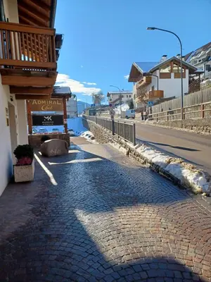 a cobblestone street in front of a building at Mansarda Cermis in Cavalese
