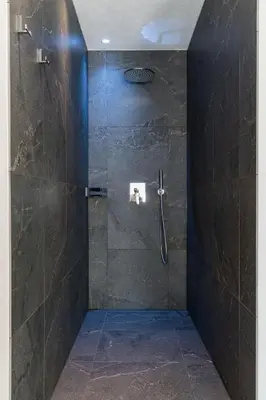 a shower with a glass door in a bathroom at Innermoser Bauernhof - Chalets in Molini di Tures