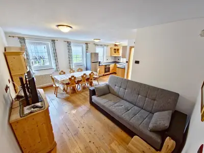 a living room with a couch and a table at Villetta Clara by AMA Val di Fassa in Vigo di Fassa