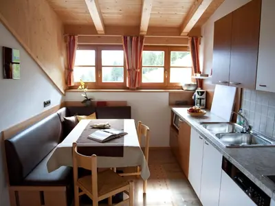 a small kitchen with a table and a sink at Chalet in Funes Valley with Dolomites Views in Funes