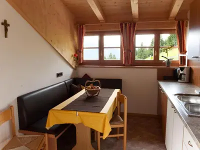 a small kitchen with a table and a sink at Chalet in Funes Valley with Dolomites Views in Funes