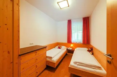 a small room with two beds and a window at Apartment in Brixen with Pool & Dolomites Views in Naz-Sciaves
