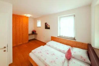 a small bedroom with a bed and a window at Apartment in Brixen with Pool & Dolomites Views in Naz-Sciaves
