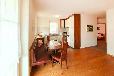 a kitchen with a table and a dining room at Apartment in Brixen with Pool & Dolomites Views in Naz-Sciaves