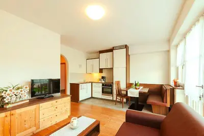 a living room with a couch and a dining room at Apartment in Brixen with Pool & Dolomites Views in Naz-Sciaves