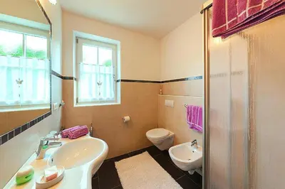 a bathroom with a sink and a toilet at Apartment in Brixen with Pool & Dolomites Views in Naz-Sciaves