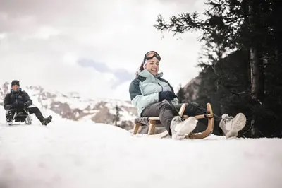 a woman sitting in a chair in the snow at Santre dolomythic home in Bressanone