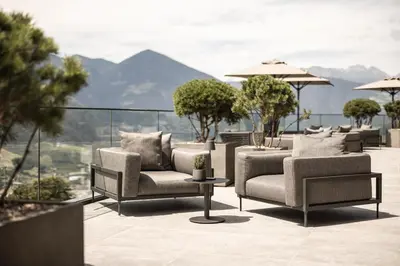 a group of chairs and tables on a patio at Santre dolomythic home in Bressanone