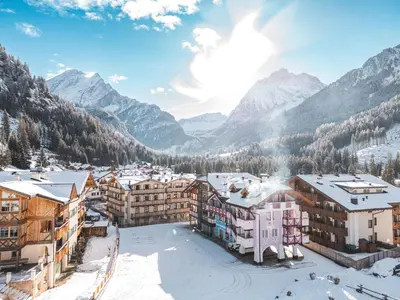 a town in the mountains in the snow at B&B Cèsa Planber Mountain View SKI-IN SKI-OUT in Canazei